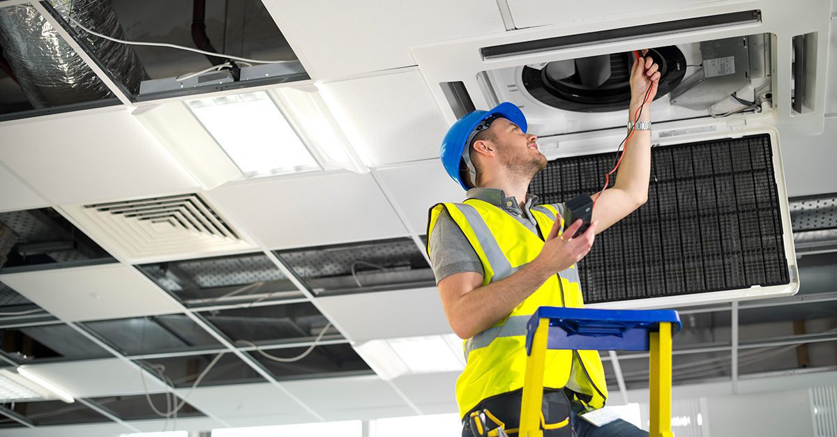 Technician doing HVAC maintenance